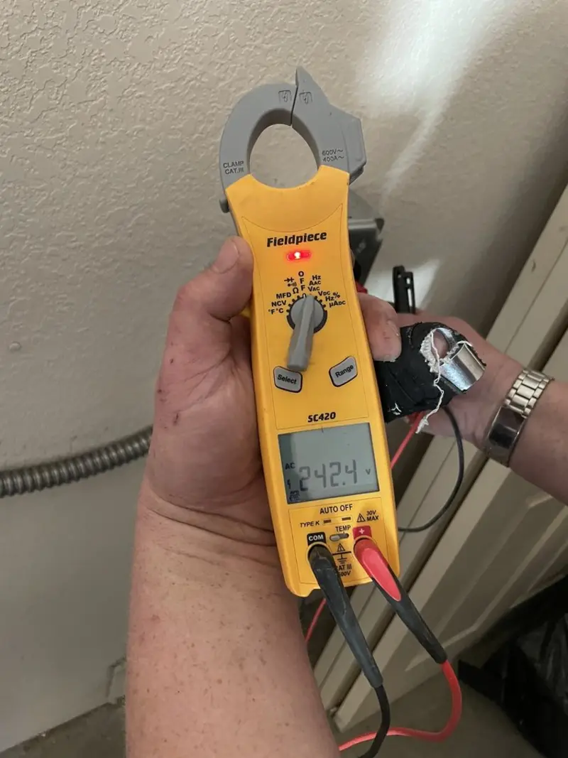 Voltage testing with clamp meter during Ceiling Fan Installation in Toledo